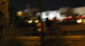 If you look carefully below the Old City walls that are lit for the Jerusalem Festival of Lights, you can make out the man on the left and the girl on the right